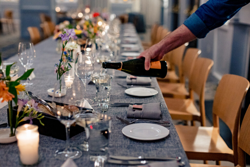 A staff pours wine at the wedding table at the line hotel dc.