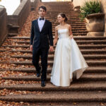 The couple is walking down the stairs at Meridian Hill Park in Washington DC.