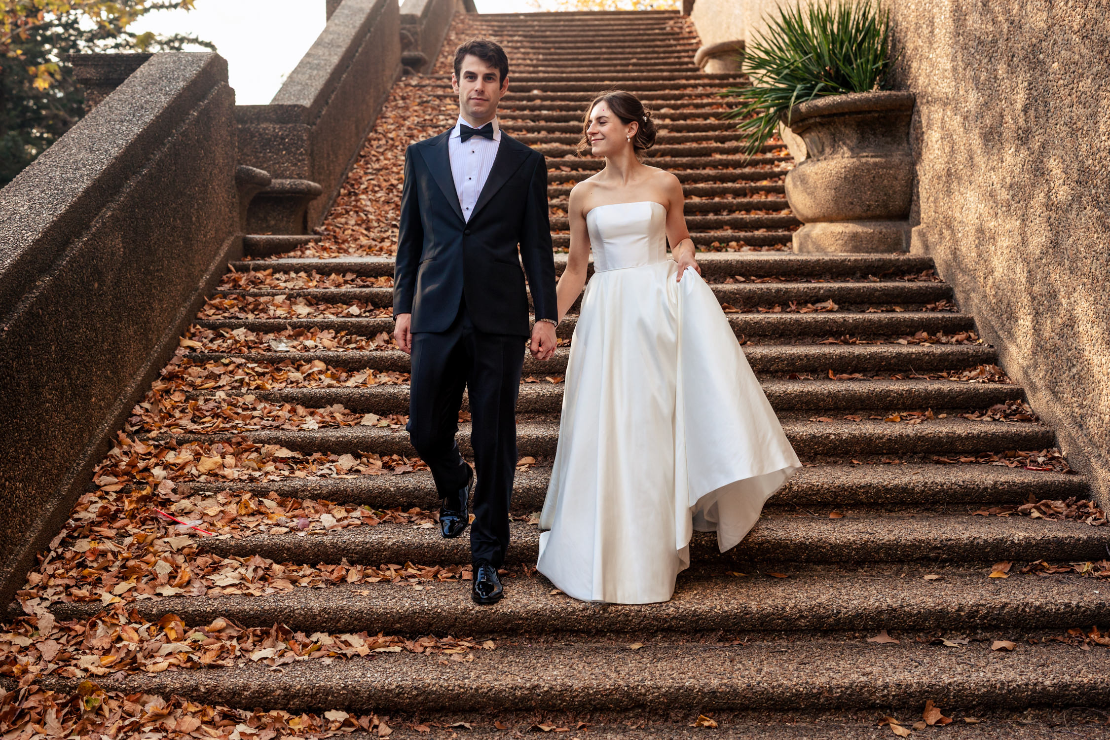 The couple is walking down the stairs at Meridian Hill Park in Washington DC.